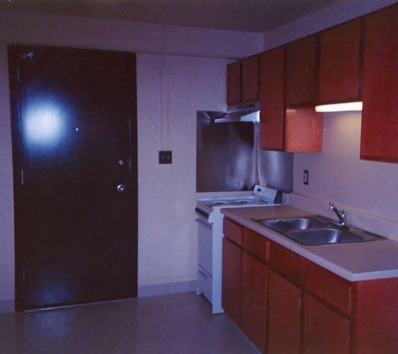 small kitchen and dark colored door 