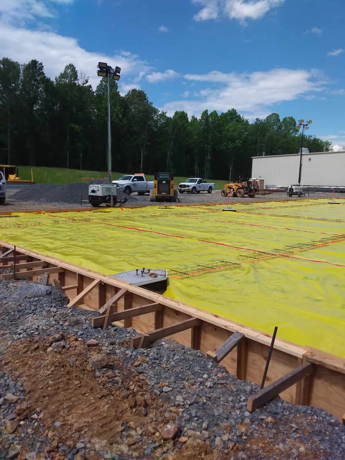 yellow liquid in a large makeshift pool at a construction site