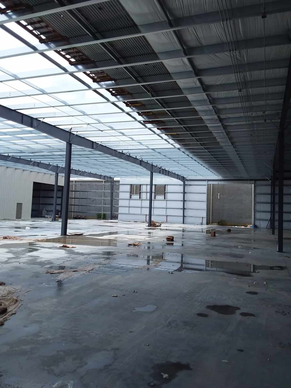 interior of partially built warehouse with wet floor