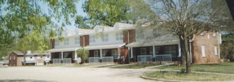 three brick houses with white accents