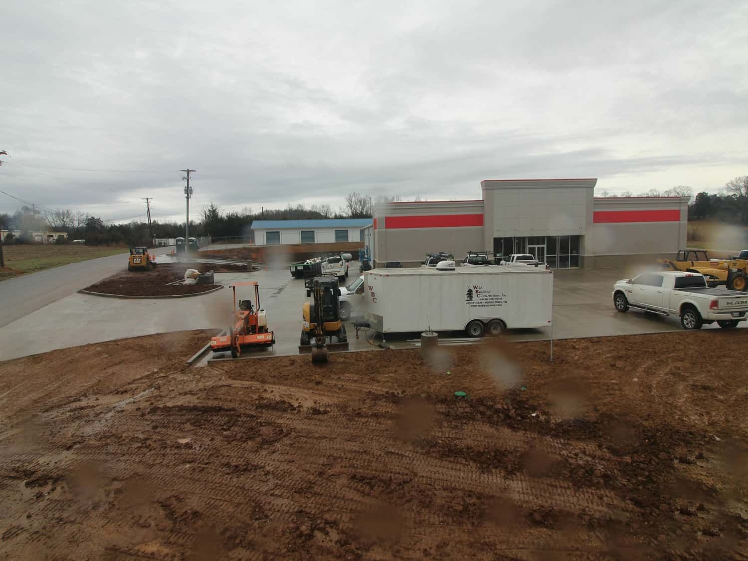 wild building trailer in front of mostly built retail building