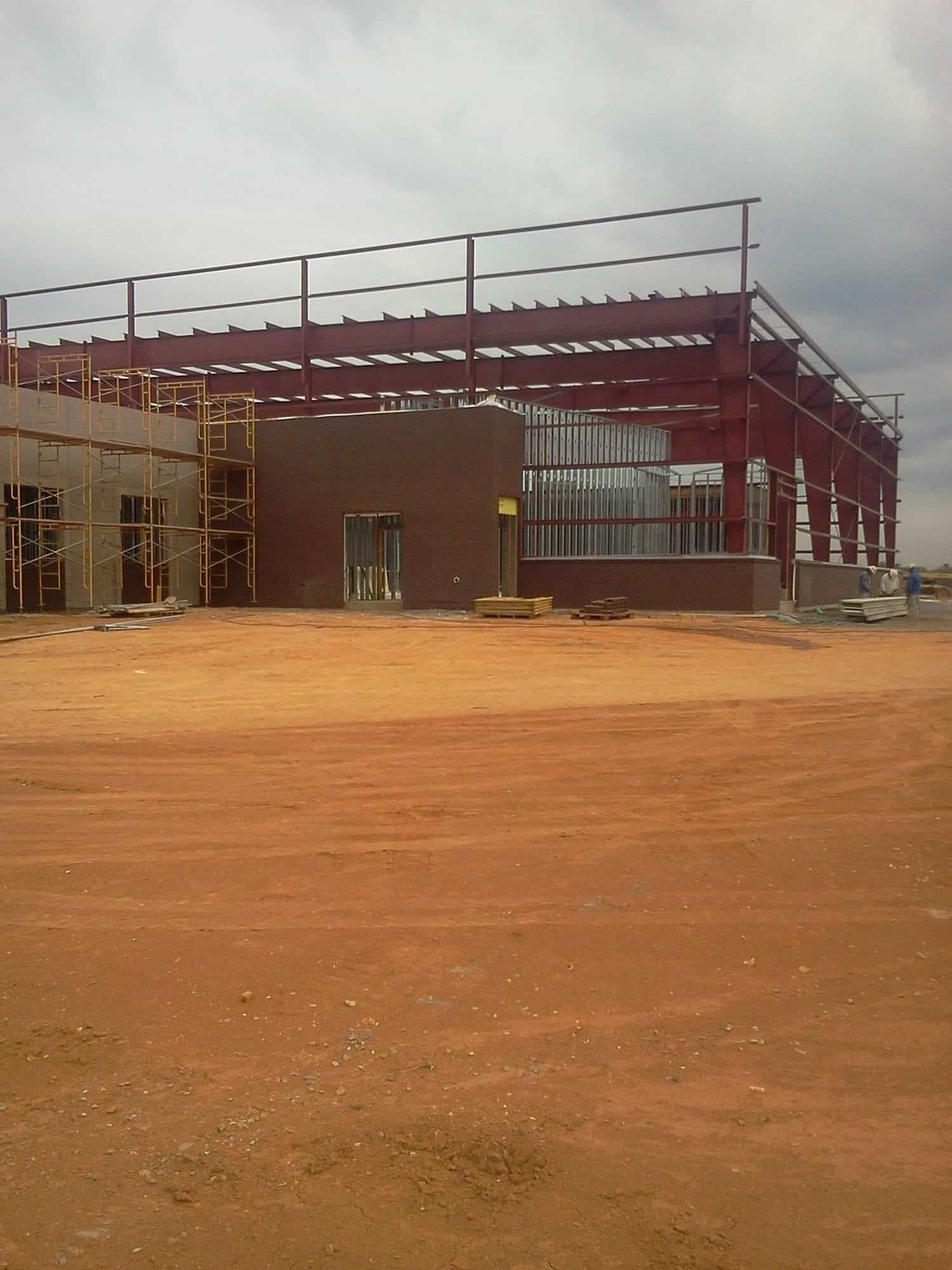 building frame on red-ish colored dirt