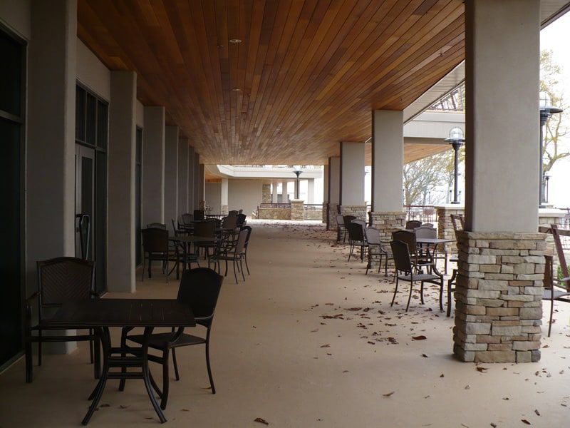 chairs and tables in an outdoor corridor