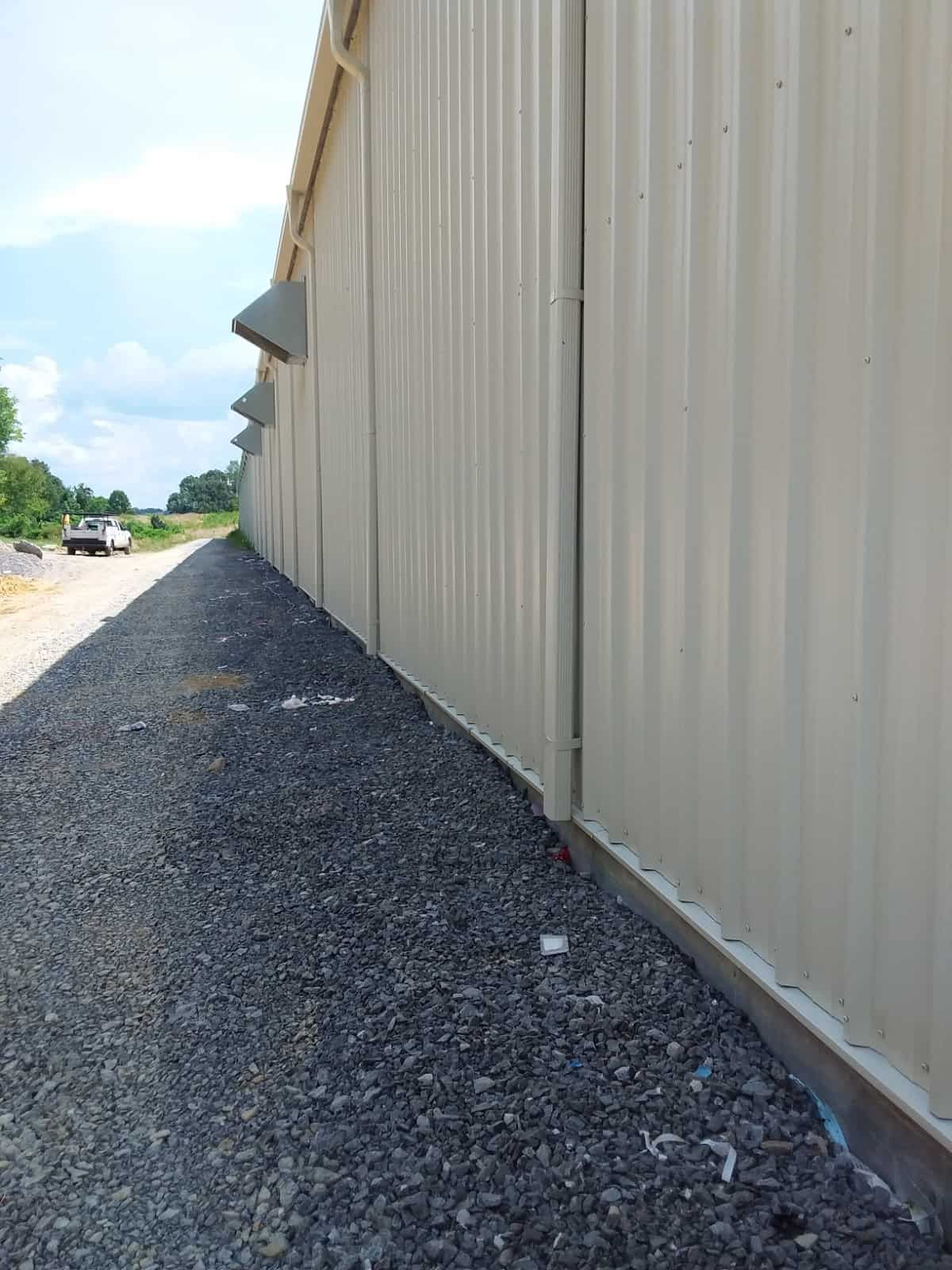 gravel ground beside metal building wall