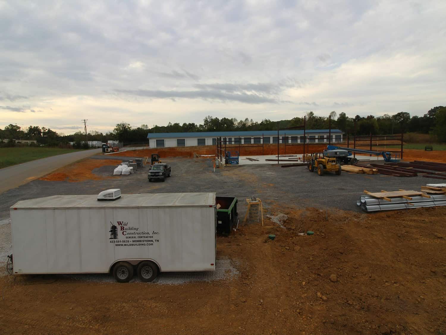wild building trailer in front of beginnings of retail building frame