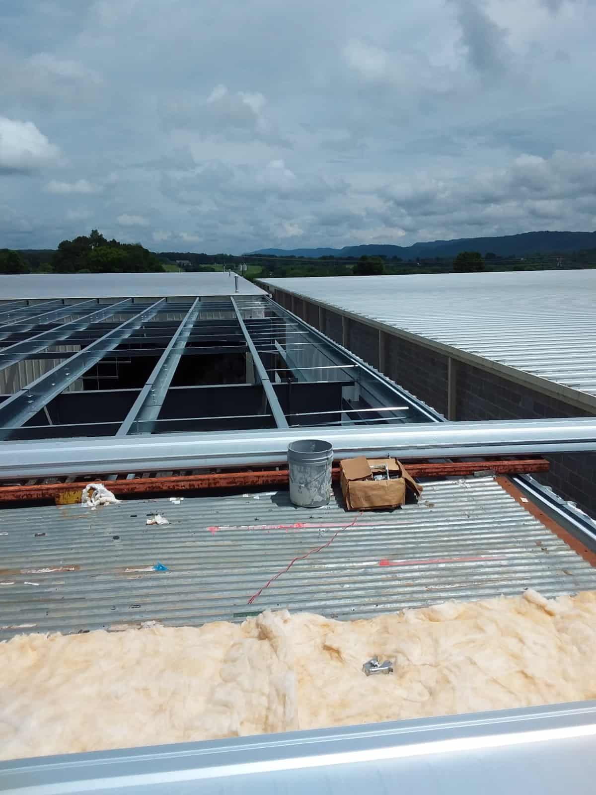 bucket and box atop of partially built warehouse roof