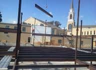 metal beam being lowered into construction area