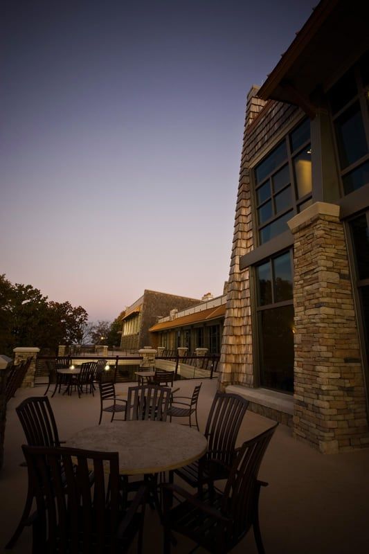 Tables and chairs on balcony in the evening