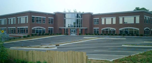 millenium square behind empty parking lot and picket fence